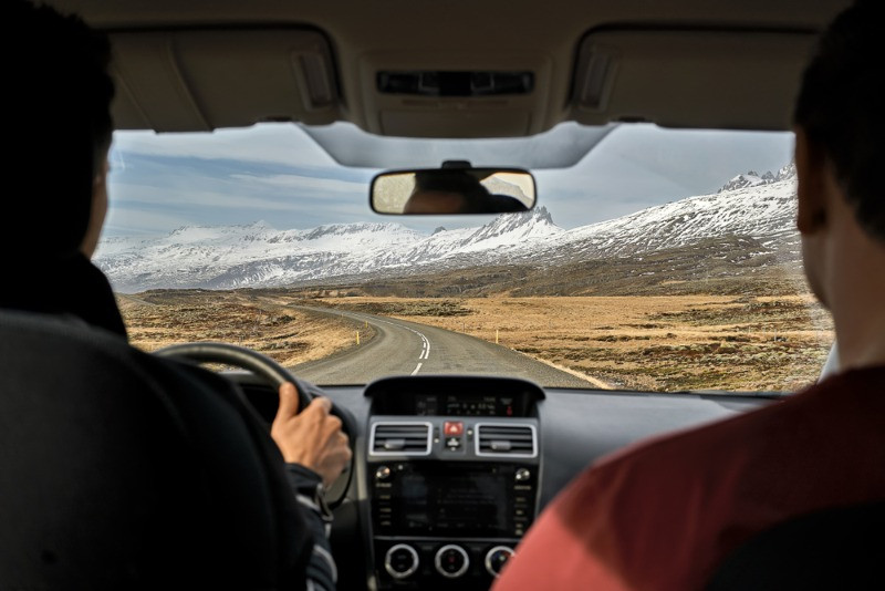 two young guys driving a rental car in Iceland
