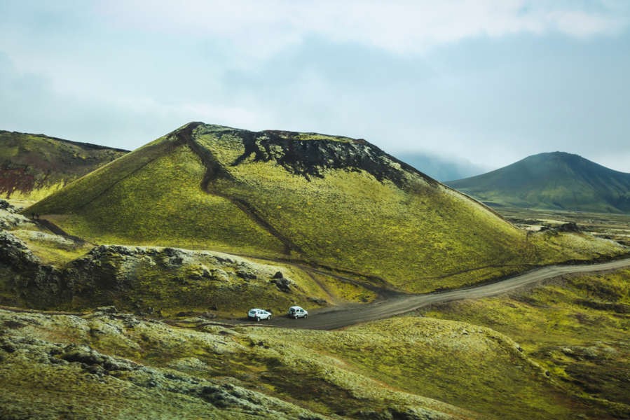 Two vehicles through the Highlands road following the icelandic traffic law