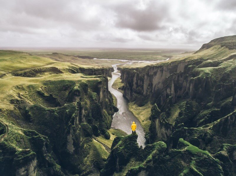 visitor overlooking a majestic gorge landscape in Iceland