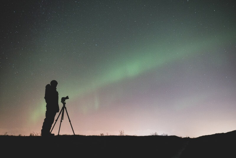 men preparing his camera to take pictures of the aurora borealis