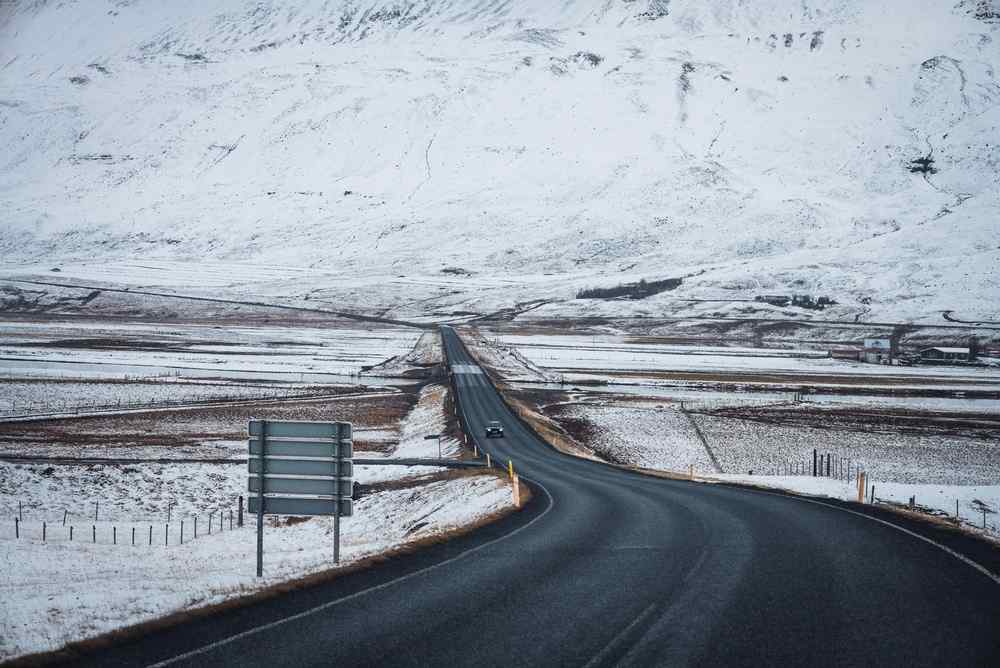 Ring Road during winter Empty paved road crossing a snowy Icelandic valley in winter.