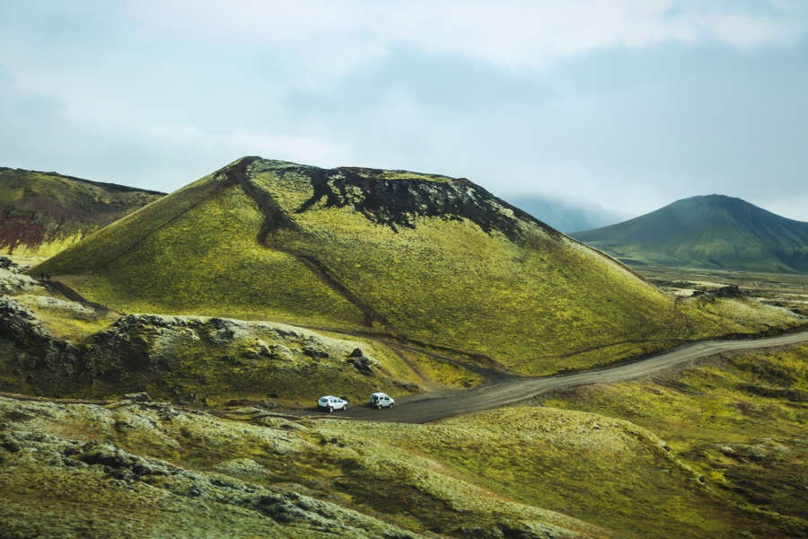 Two cars driving to Landmannalaugar surrounded by a beautiful landscape