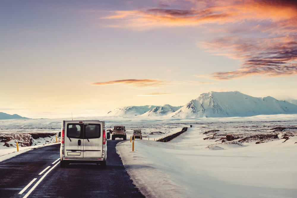Camper driving in winter in iceland with a beautiful snowy landscape