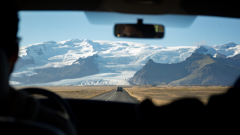 Driving in Iceland on the Ring Road with beautiful views on the background