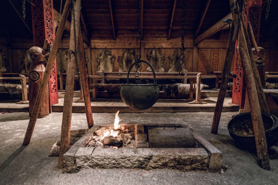 interior of a viking house with a bonfire in the central area