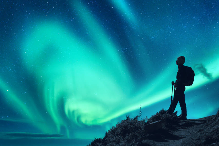 Visitor watching the mesmerizing Northern Lights in the sky