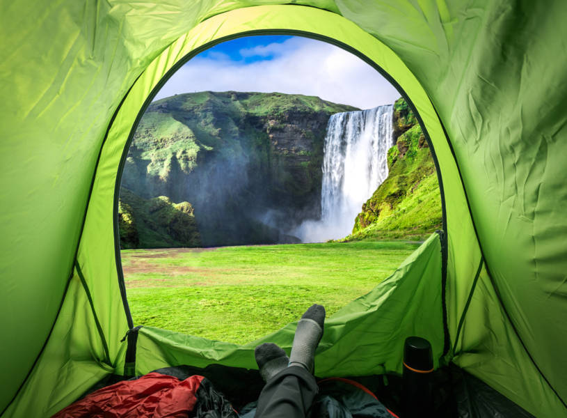Tent camping with views to a waterfall in Iceland