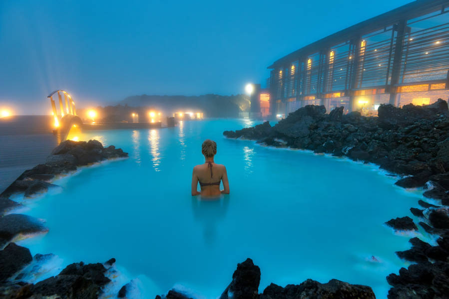 Women taking a relaxing bath at a hot spring a wellness activity in Iceland