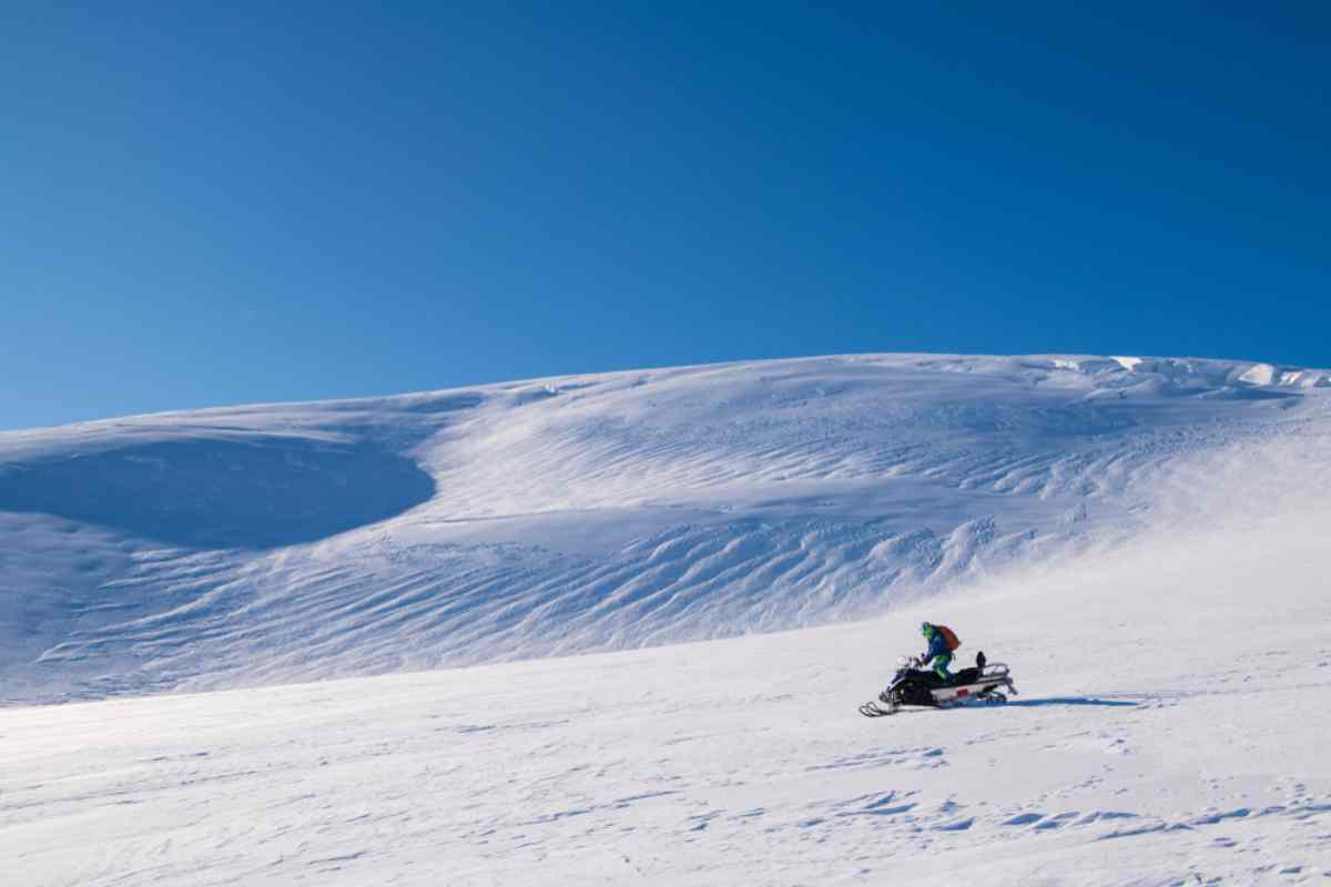 Close up snowmobile against snowed hills