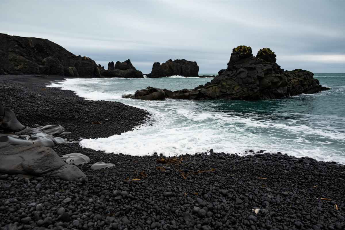 Black sand beach in Iceland with rock formations