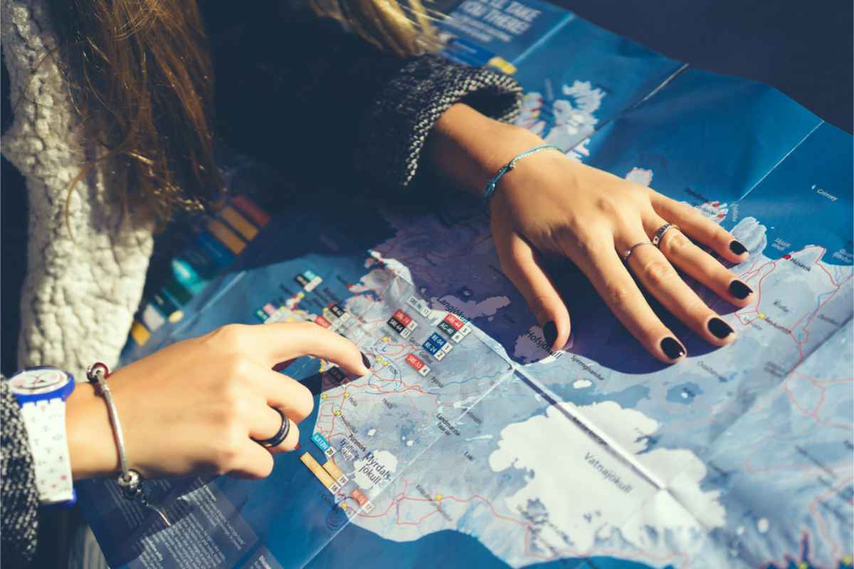 Woman pointing out a place on a map of Iceland