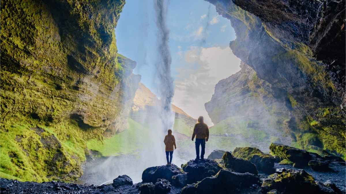 Couple viewing Kvernufoss from behind