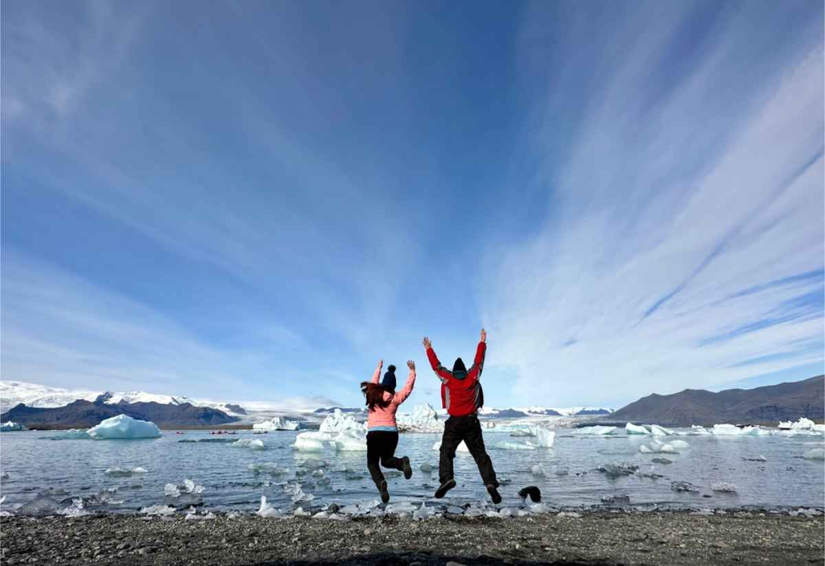 Couple jumping in joy while int heir honeymoon in Iceland