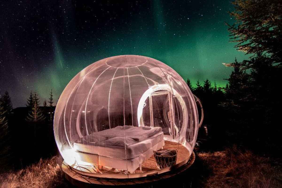 Bubble hotel with the aurora shining in the back