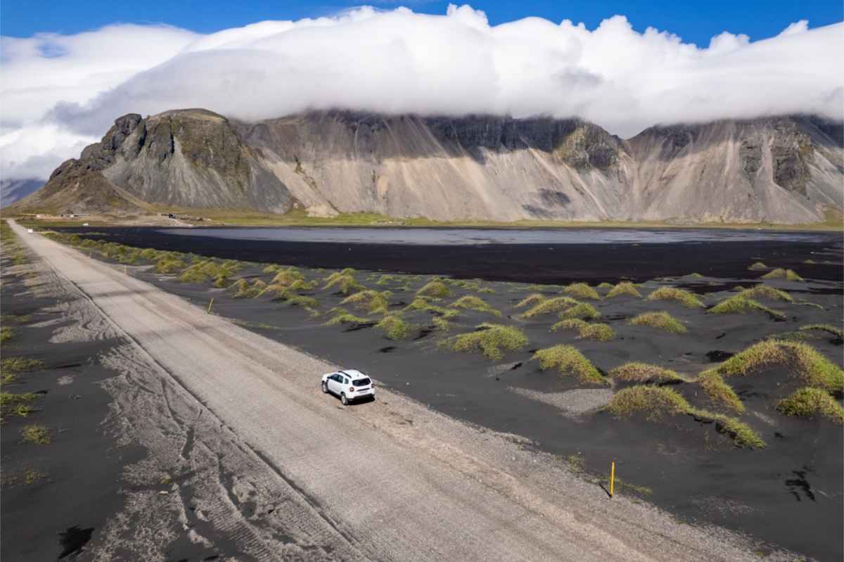 4x4 white car on the road to Vestrahorn, Iceland