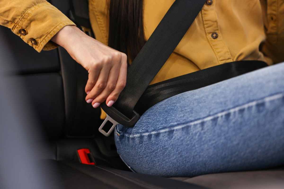 Frau schnallt sich im Auto an