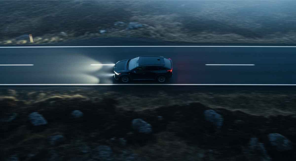 Coche 2WD con las luces encendidas mientras circula por la carretera