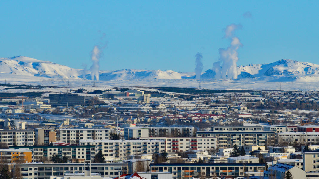 Panoramic view of Reykjavik with geothermal vapor coming out from the ground
